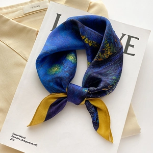 Artistic Van Gogh Starry Night print silk scarf tied in a bow on a white magazine