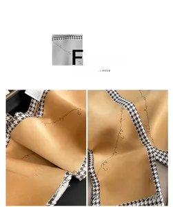 Detail of imitation silk scarf with houndstooth edge and elegant gold texture
