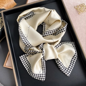 Elegant champagne silk skinny scarf with houndstooth edge and letter print on tray