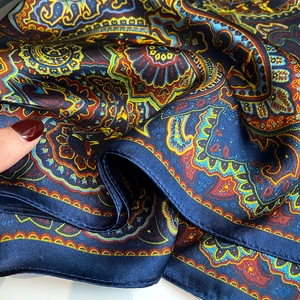 Detail of premium silk scarf showing vintage paisley print and fine rolled edges