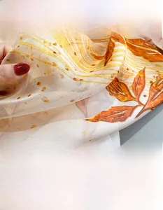 Detailed macro view of semi-transparent floral chiffon scarf with smooth texture