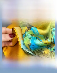 Macro shot of fine hand-rolled edges on a silk scarf with landscape print details