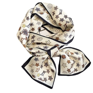 Elegant floral print skinny silk scarf with black border tied in a stylish bow knot