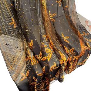 Oversized long scarf with golden leaf print on black fabric, lightweight sun protection shawl
