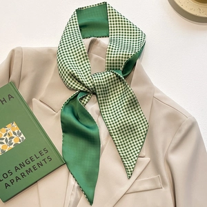 Elegant green checkered silk scarf on beige blazer with aesthetic book styling