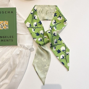 Fresh grass green silk skinny scarf with floral print on white dress and green book