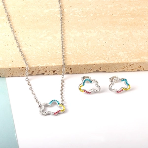 Detail of cutout cloud jewelry set with colorful rhinestones on stone background