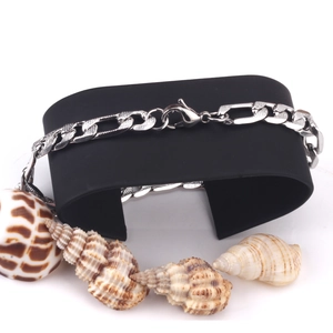 Detail of 8mm silver steel Figaro chain with lobster clasp on a black display stand