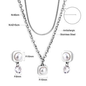 Detailed view of stainless steel necklace set with pearls and crystal square charms