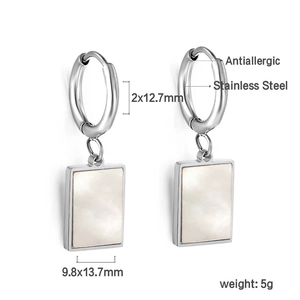 Macro view of 18K gold-plated stainless steel earrings with white shell inlay details