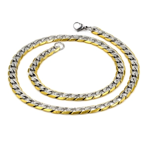 Detail of two-tone gold and silver Cuban chain necklace with textured links and lobster clasp