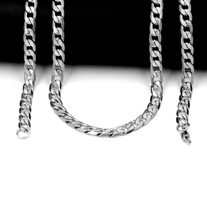 Detail of silver Cuban link chain showing intricate diamond-grid engraved texture