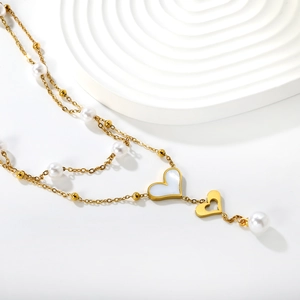 Double-layered gold heart necklace with white pearls and mother-of-pearl heart pendant