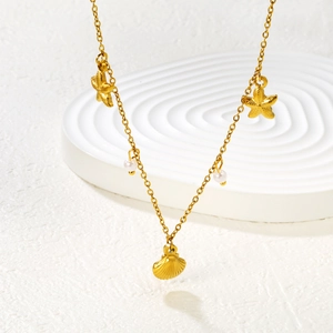 Gold ocean necklace with seashell, starfish charms and white pearls for summer