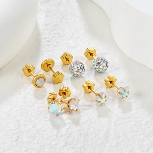 Colorful rhinestone and opal stainless steel stud earrings set on a white stone background