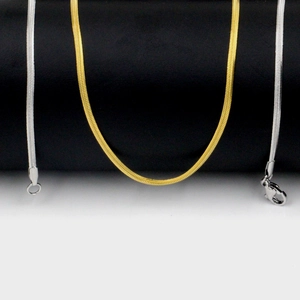 Detail of 2mm minimalist gold and silver snake chains with lobster clasp and sleek scales