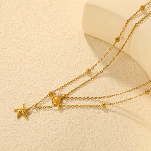Double layered gold stainless steel necklace with starfish pendant and shell accent