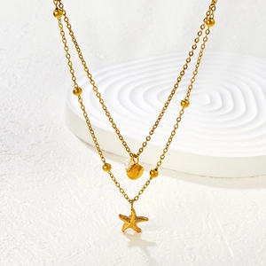 Double-layered gold stainless steel necklace featuring starfish and shell shell pendants