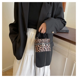 Detailed view of leopard print mini box bag with chain strap and dual zipper closure