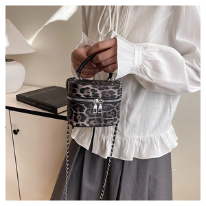 Detail of leopard print mini box bag featuring metal chain strap and dual zippers
