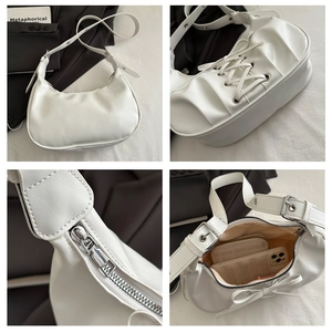 Détails des lacets, de la quincaillerie argentée et de la capacité intérieure du sac blanc