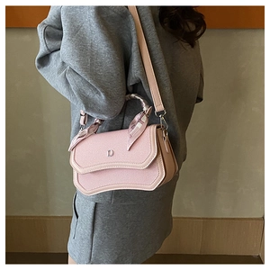 Detail of pink structured handbag with silk scarf handle and silver metal D logo
