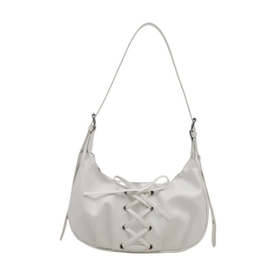 White faux leather bow hobo bag with adjustable long strap and lace-up details