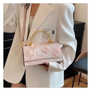 Detail of pink lace handbag with 3D butterfly embroidery and gold metal round handle