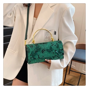 Close-up of green crossbody bag with 3D butterfly embroidery and gold metal handle