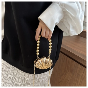 Mini gold shell bag with round bead handle and ball chain strap for cosmetics