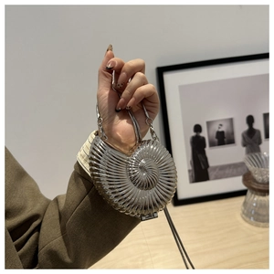 Artistic silver nautilus shell evening bag with metallic finish and snake chain detail