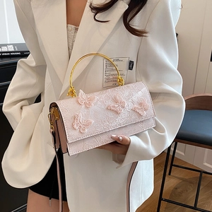 Pink lace crossbody bag with butterfly embroidery and golden metal ring handles