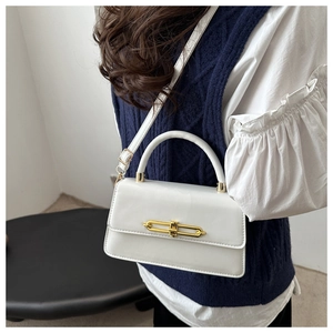 Detailed view of white PU leather bag with chic gold buckle and adjustable strap