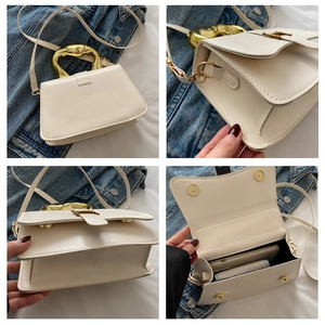 Details des goldenen Griffs und des Innenraums der cremefarbenen Leder-Box-Tasche