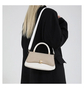 Detail of color-block crossbody bag with straw weave texture and white leather finish