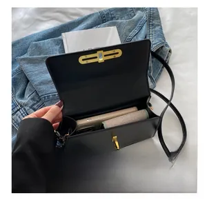 Detail view of the black leather box bag showing spacious interior for a phone