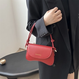 Chic red wavy-bottom leather crossbody bag with thin knotted shoulder strap for women