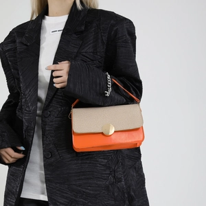 Chic orange and beige color-block crossbody bag with gold round clasp and woven texture