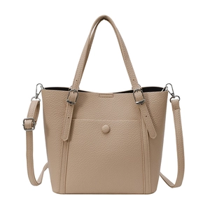 Minimalist beige pebble leather tote bag with silver hardware and adjustable straps