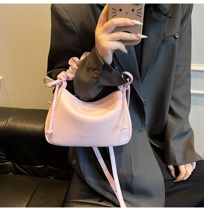 Pink pleated handle crossbody bag with knotted sides and fashion logo detail