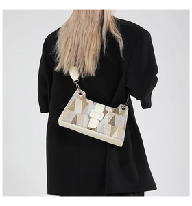 Detailed back view of a geometric patterned shoulder bag on a black blazer jacket