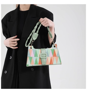 Detail of the colorful geometric print underarm bag with woven shoulder strap
