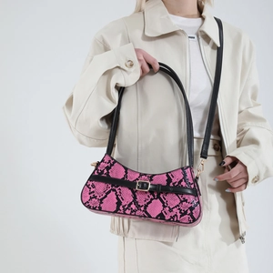 Pink faux snakeskin baguette bag with black straps and golden metal buckle for women