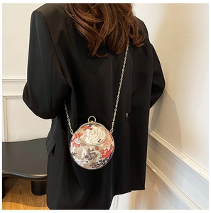 Detailed back view of a spherical evening bag with floral embroidery and gold chain