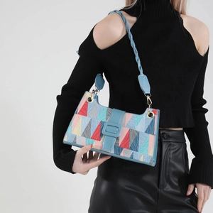 Fashionable geometric patchwork shoulder bag with colorful triangular patterns and woven strap