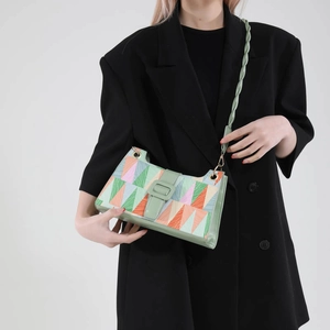 Geometric color-block underarm bag with woven strap and textured print pattern for women