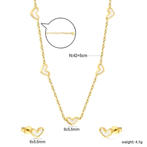 Golden stainless steel jewelry set featuring white heart pendants with necklace and earrings