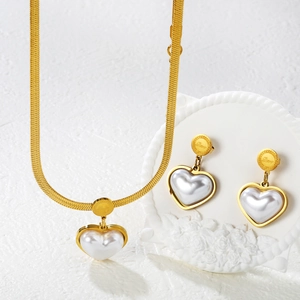 Golden heart pearl jewelry set featuring Love engraved necklace and matching earrings