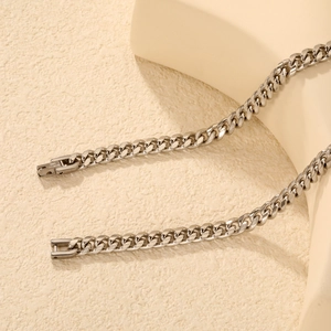 Collier chaîne gourmette hip-hop en acier inoxydable argenté sur socle minimaliste