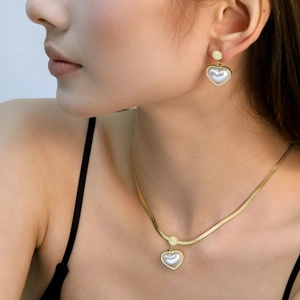 Golden snake chain necklace and heart pearl earring set featuring Love engraving